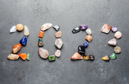 2023 - inscription of mineral stones on a black background. The concept of the New Year.