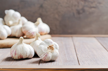 Garlic bulbs on a wooden background. Copy space.の写真素材