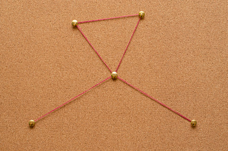 Corkboard detective with pins and threadの写真素材