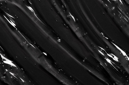 Transparent cosmetic moisturizing gel or skin serum on a black backgroundの写真素材
