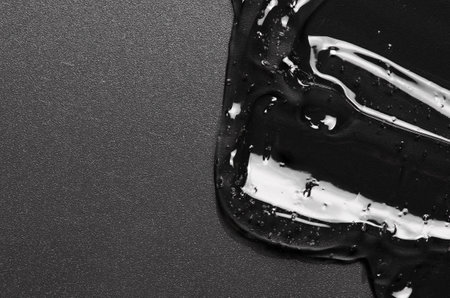 Transparent cosmetic moisturizing gel or skin serum on a black backgroundの写真素材