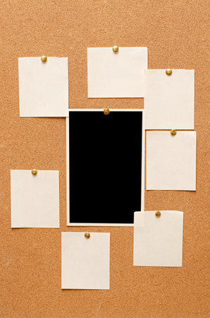 Blank paper notes and an empty photo are pinned to a cork board. The concept of detective...