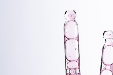 Skin serum in a pipette. A cosmetic product for body care. White background. Copy space.の写真素材