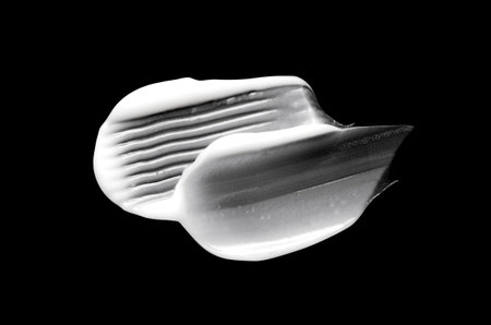 A sample of white body cosmetics on a black backgroundの写真素材