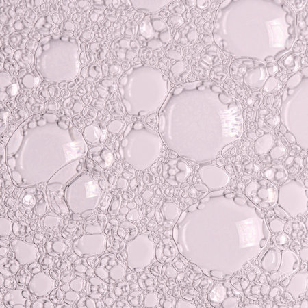 The texture of the foam of shower gel or soap suds. Macrophotography.