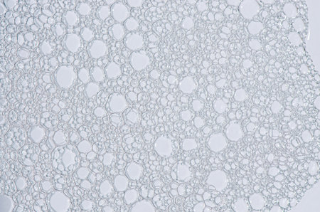 The texture of the foam of shower gel or soap suds. Macrophotography.