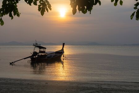 Silhouette of long tail boat with sunset background , Koh yao yai , Thailand.の写真素材
