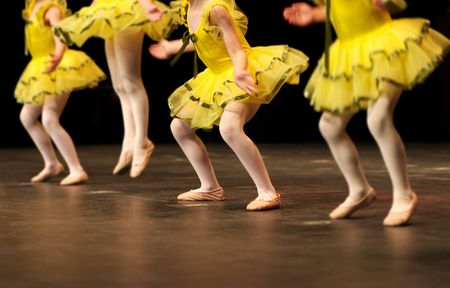 a group of young dancers show off their talent and bright costumes - image highlights a narrow depth of fieldの写真素材