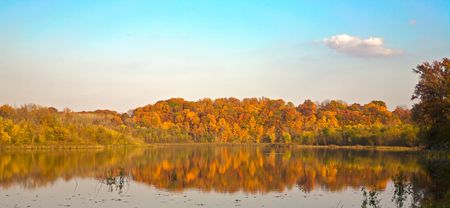 Fall colors on a calm lake - with beautiful reflectionsの写真素材