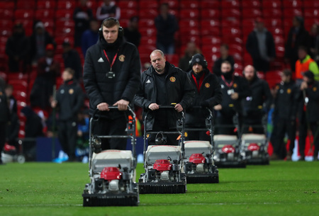 MANCHESTER, ENGLAND - FEBRUARY 12 2019: Ground staff prepare the pitch after the Champions League match between Manchester United and Paris Saint-Germain at Old Trafford Stadium.のeditorial素材
