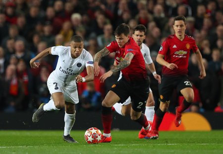 MANCHESTER, ENGLAND - FEBRUARY 12 2019: Kylian Mbappe of PSG and Victor Lindelof of Manchester United during the Champions League match between Manchester United and Paris Saint-Germain at Old Trafford Stadium.のeditorial素材