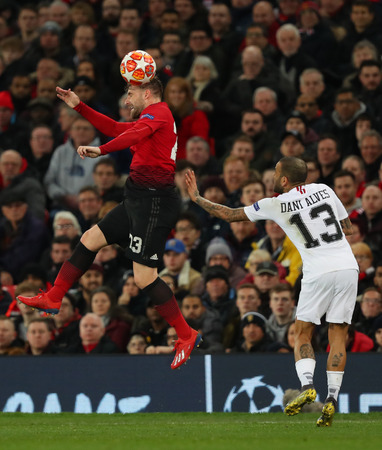 MANCHESTER, ENGLAND - FEBRUARY 12 2019: Luke Shaw of Manchester United and Dani Alves of PSG during the Champions League match between Manchester United and Paris Saint-Germain at Old Trafford Stadium.のeditorial素材