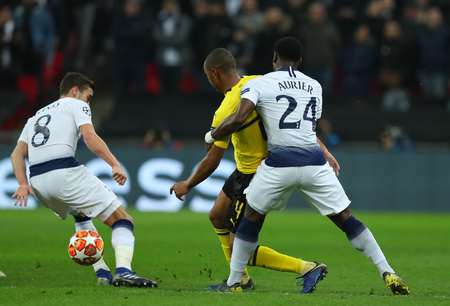LONDON, ENGLAND - FEBRUARY 13 2019: Harry Winks of Tottenham Abdou Diallo of Dortmund and Serge Aurier compete during the Champions League match between Tottenham Hotspur and Borussia Dortmund at Wembley Stadium, London.のeditorial素材