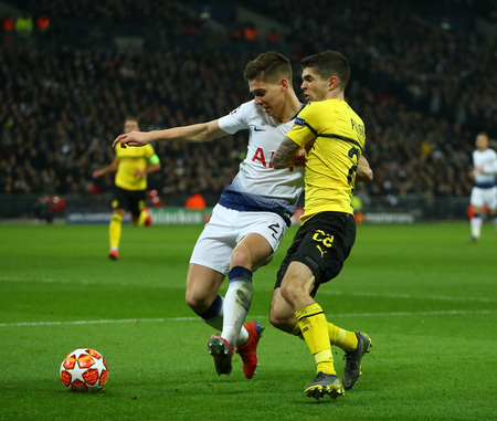 LONDON, ENGLAND - FEBRUARY 13 2019: Juan Foyth of Tottenham and Christian Pulisic of Dortmund during the Champions League match between Tottenham Hotspur and Borussia Dortmund at Wembley Stadium, London.のeditorial素材