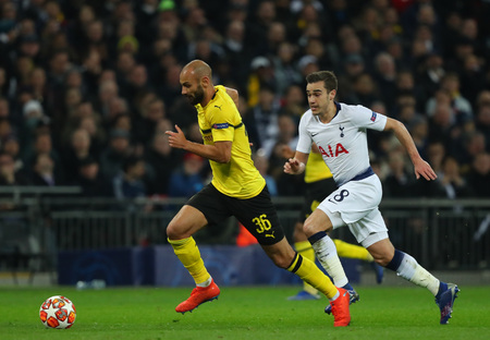 LONDON, ENGLAND - FEBRUARY 13 2019: Omer Toprak of Dortmund and Harry Winks of Tottenham chase the ball during the Champions League match between Tottenham Hotspur and Borussia Dortmund at Wembley Stadium, London.のeditorial素材