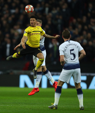 LONDON, ENGLAND - FEBRUARY 13 2019: Jadon Sancho of Dortmund and Toby Alderweireld of Tottenham compete for the ball during the Champions League match between Tottenham Hotspur and Borussia Dortmund at Wembley Stadium, London.のeditorial素材