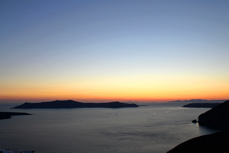 Sunrise in Greek Island of Santorini with Ocean and Mountasinsの写真素材