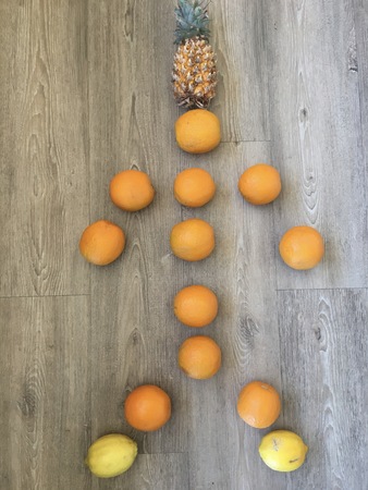 Fruit in the shape of a person on a floor.の写真素材
