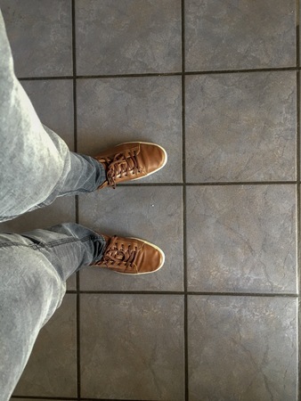Trying on second hand leather shoes, looking down on them for the first time.の写真素材
