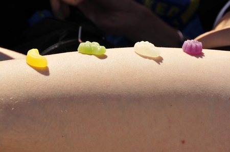 candy on the nakes leg of a womanの写真素材