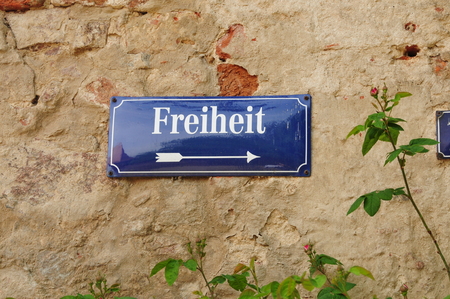 german sign at a stone wallの写真素材