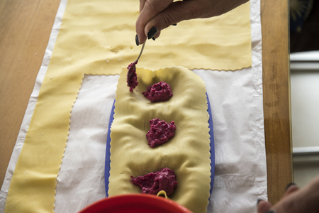 Woman hand filling the italian pasta tortelliniの写真素材