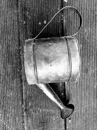 Old rusty watering can in black and whiteの写真素材