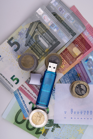 Money with USB stick and coinsの写真素材