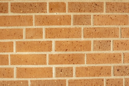 red brick wall as background with large white jointsの写真素材