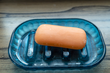red organic soap on a blue plastic int the sinkの写真素材