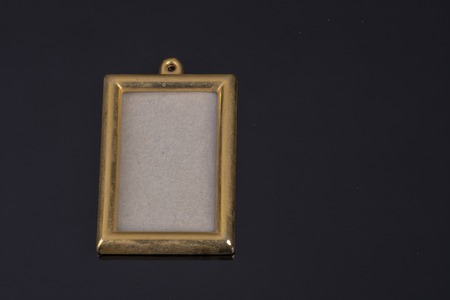 golden empty picture frame on black background with free text spaceの写真素材