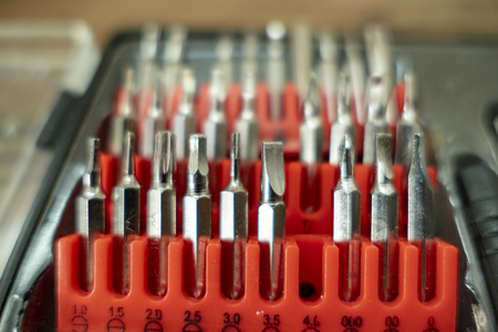 Bit set with different screws Bits in a red plug box Toolboxの写真素材