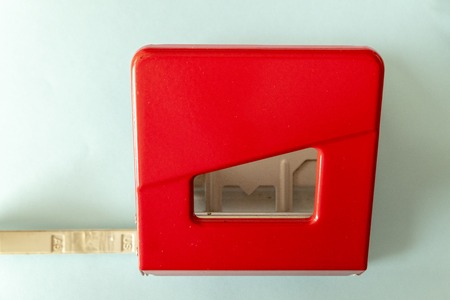 red hole punch on blue background in the officeの写真素材