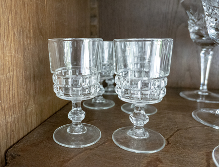 old vintage glasses for cocktail and wine in a wooden showcase in the living roomの写真素材