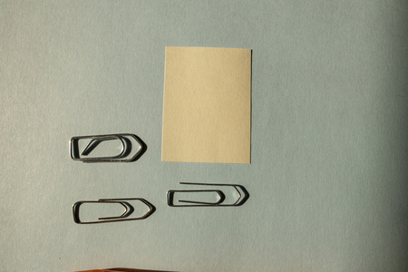 attached yellow note and orange pen on blue backgroundの写真素材