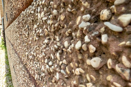 Wall with coarse stones in cement for the backgroundの写真素材