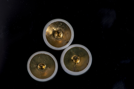 three white pins on a black background with the tip up sharp and pointedの写真素材