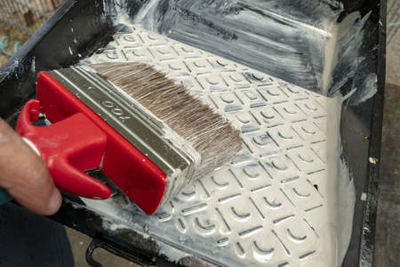 glaze a wooden bench with a red wide brushの写真素材
