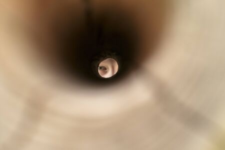 Binoculars with eye in a holeの写真素材