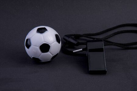 whistle with football on black backgroundの写真素材