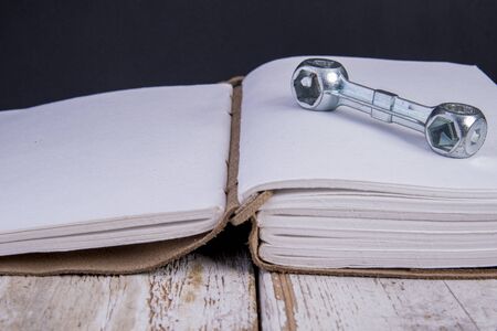 Opened diary with craftsmen utensilsの写真素材