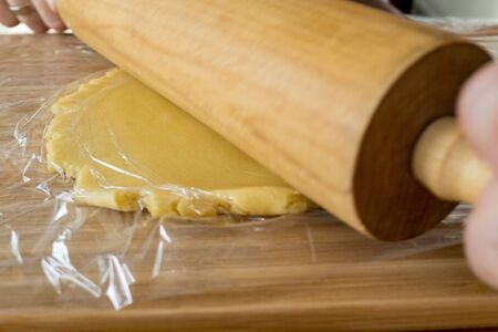 Roll out dough with rolling pinの写真素材