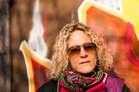 blonde woman against a colorful background