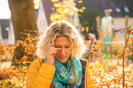 Blonde European woman inserts contact lensの写真素材