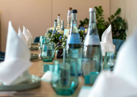 Table set in a restaurant with table decorationの写真素材