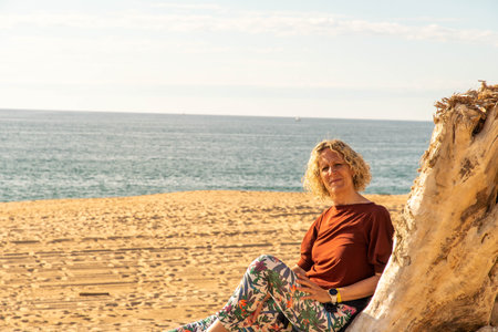 Boy looking into the distance with cap on the beach at the Atlantic Oceanの写真素材