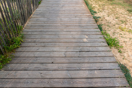 Old wooden plank footbridge leads over the duneの写真素材
