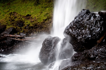 water impacting rocksの写真素材