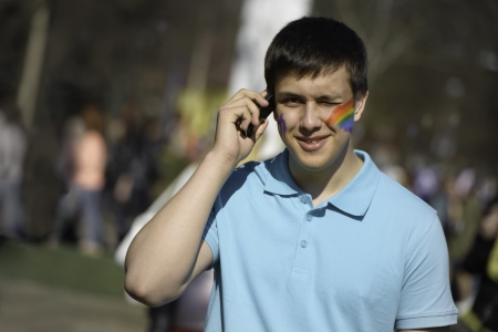 MOSCOW - MAY 2: A young guy with a rainbow face paint at Moscow City center on May 2, 2013 in Moscow, Russiaのeditorial素材