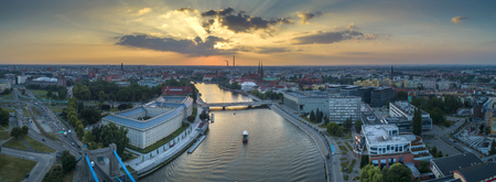 A bird's eye view of bridges, a ship on the river and the setting sun - Wroclaw, Polandの写真素材